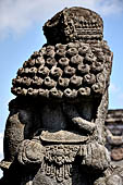 Candi Panataran - Main Temple. Back side of one of the giant guardians to left of the staircase of the temple with detail of the elaborately curled coiffure. 